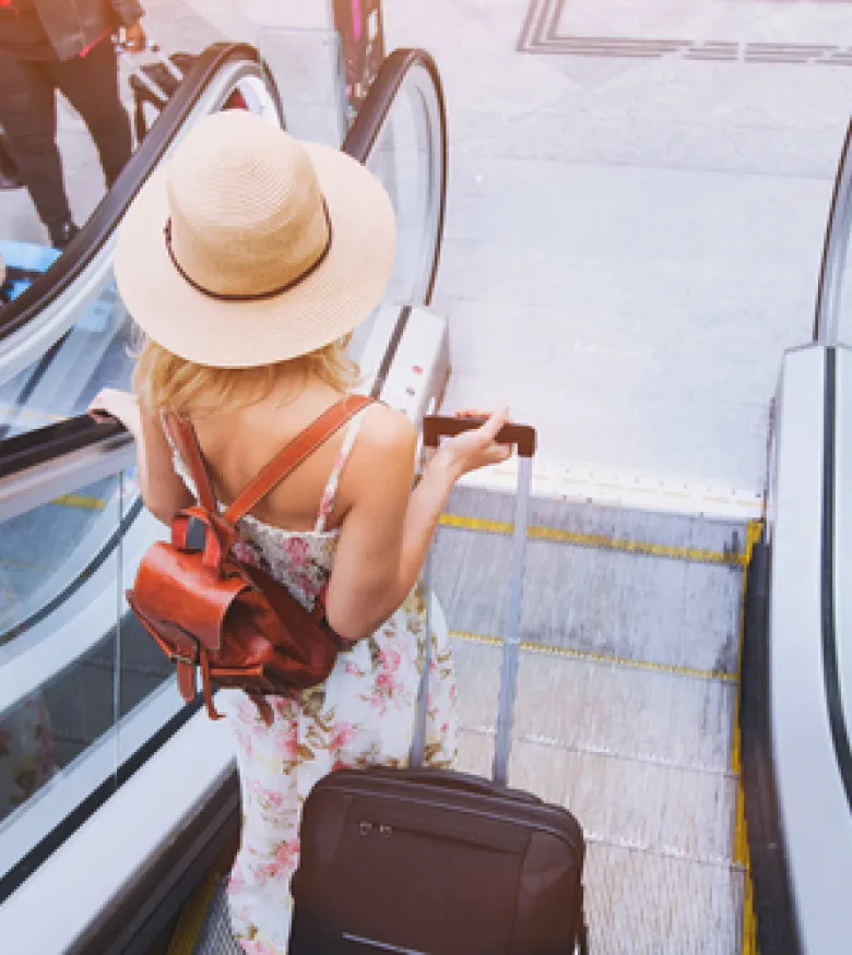 Where Can I Find the Best Airport Accident Lawyers in Owensboro, KY - woman on airport escalator