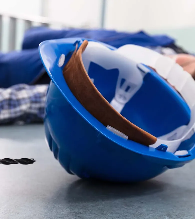 Helmet flipped over on ground in front of man on floor