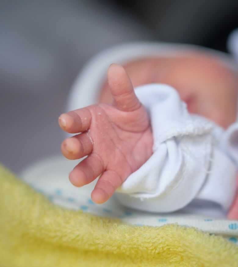 Close-up of a newborn baby's hand, potential birth injury representation for legal services in Illinois.