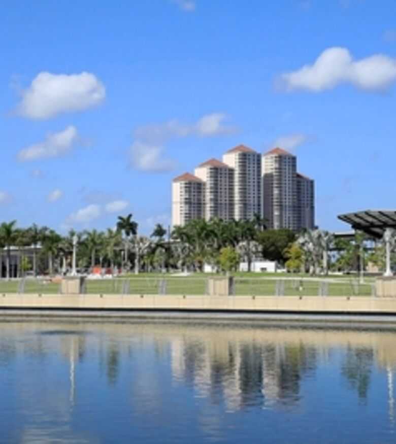 Serene waterfront in Fort Myers with city buildings, a personal injury lawyer is here to help.