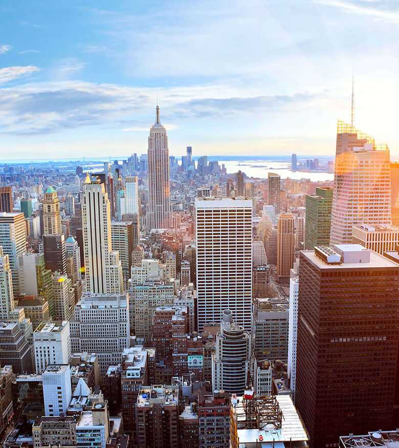 Sunlit New York City skyline, a bustling urban area ripe for personal injury lawyers.