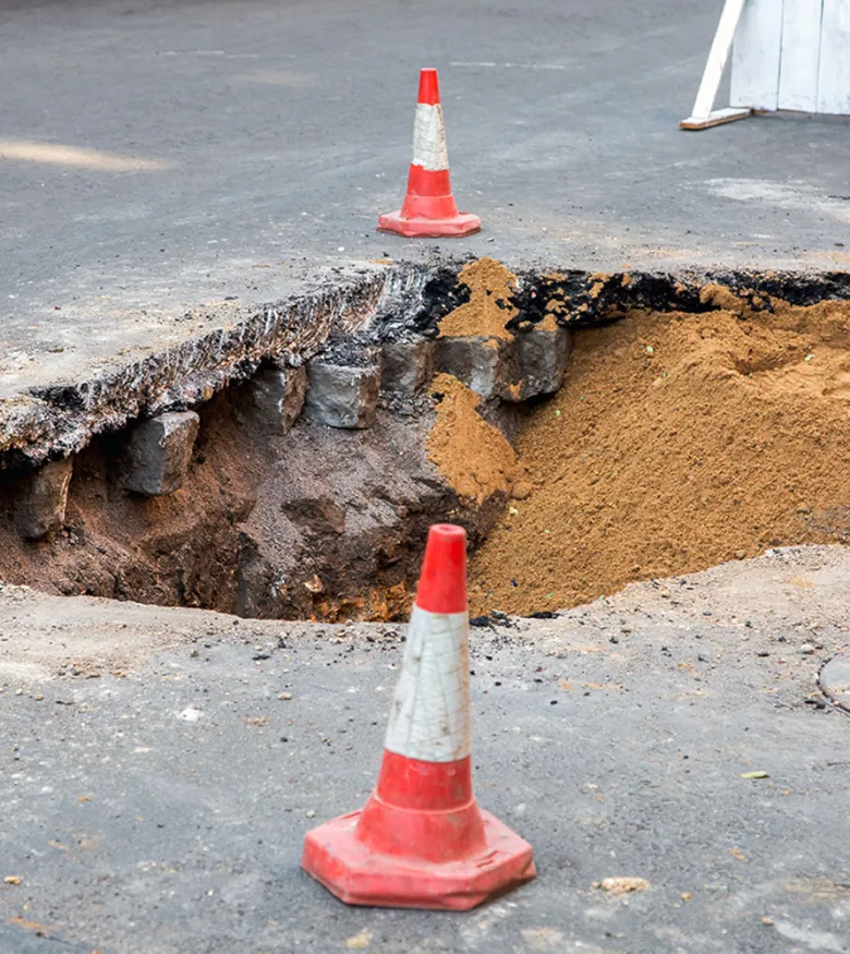 Sinkhole Attorneys in Atlanta, GA - sinkhole in the street with orange cones