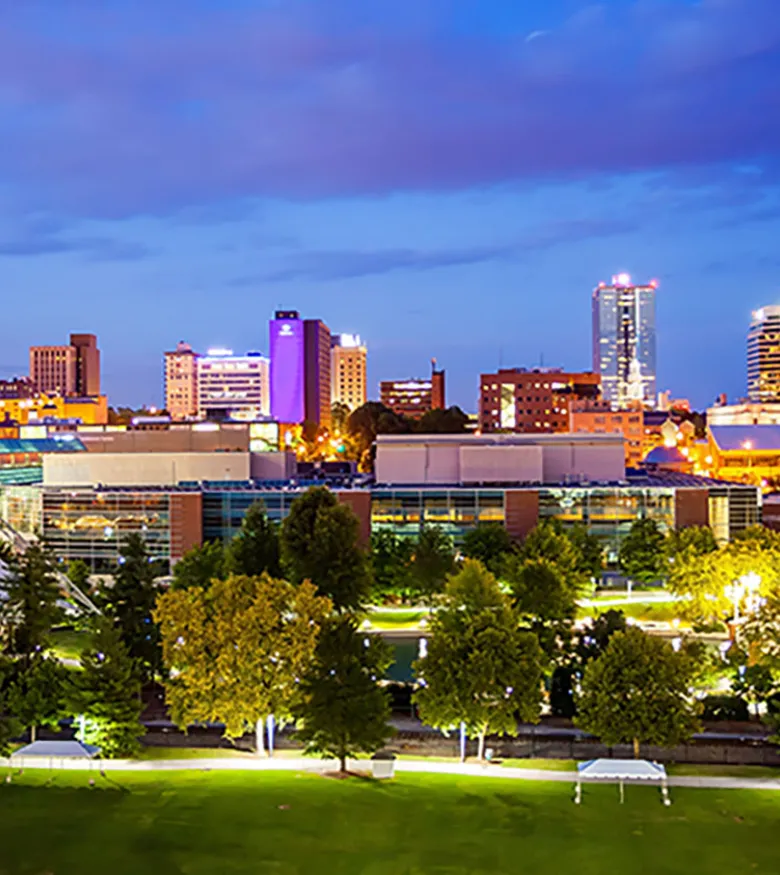 lluminated skyline of Knoxville at twilight with green park in the foreground, a potential market for Personal Injury Lawyers.