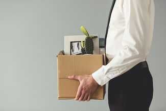 Man with office supplies in box