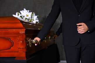 Men in suits holding casket