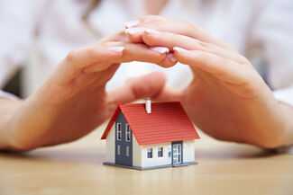 Home Insurance Claim Lawyers in Hilton Head, SC - Person covering small house with hands