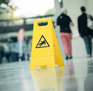 Best Airport Accident Lawyers in Jacksonville - caution it's slippery sign