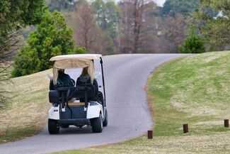 Golf Cart Accident Lawyer in Kissimmee - two men driving golf cart 
