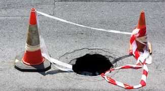 Sinkhole Claims: Hiring an Attorney in Naples - sinkhole in the street