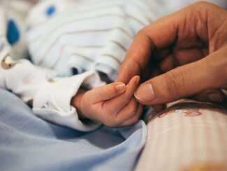 Tampa Birth Injury Attorneys - newborn baby holding mom's hand