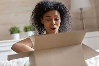 Naples Product Liability Lawsuits - woman opening box in shock