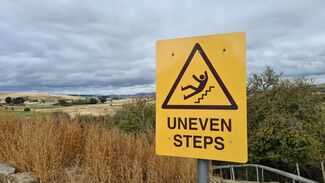 What Should I Do After a Slip and Fall in Indianapolis - uneven steps sign