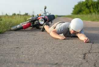 Motorcycle Accident Lawyers in Owensboro, KY - Bike rider on floor after accident