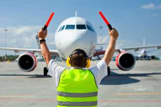 Atlanta Aviation Accident Attorneys- Man directing plane
