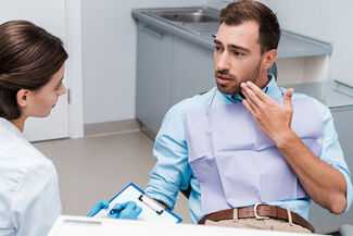 Man talking to Dentist