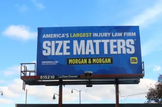 Billboard against a blue sky reads, "America's Largest Injury Law Firm. Size Matters. Morgan & Morgan" in bold text. Tone is assertive and promotional.