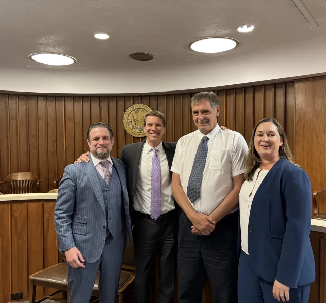 morgan & morgan attorneys with client after a large win